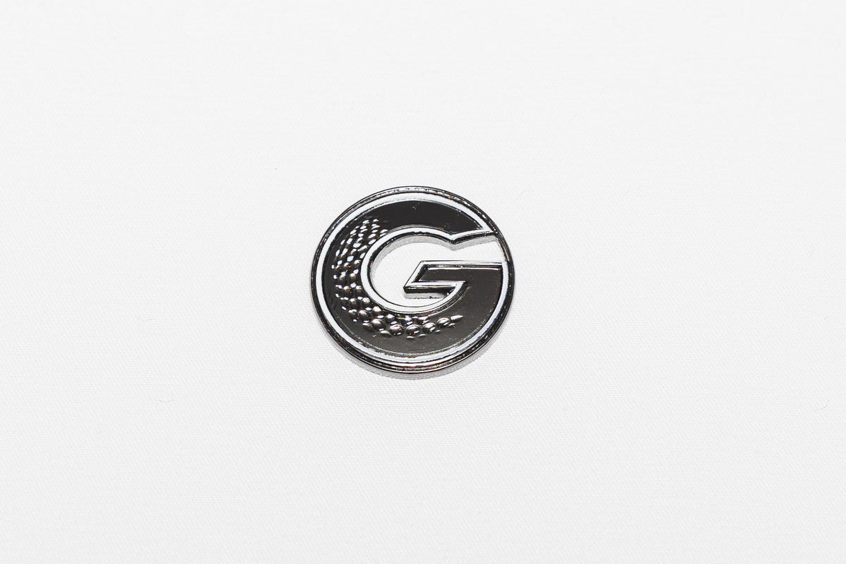 G•MARK Black with White Trim magnetic golf ball marker, angle view